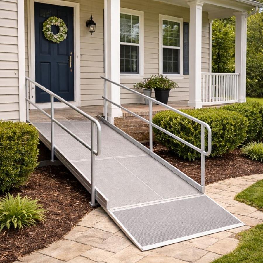 
Custom aluminum modular wheelchair ramp with safety handrails leading to a residential front porch in Jekyll Island, GA.