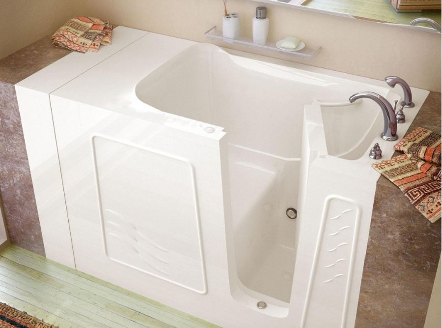 White walk-in bathtub with built-in door and safety features installed in a residential bathroom, ideal for seniors and accessibility-focused homes in Beaufort, SC.