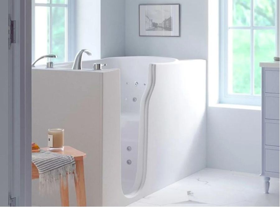 Modern white walk-in tub with low-entry door and therapeutic jets in a bright residential bathroom, designed for safe and comfortable bathing in Bluffton, SC.