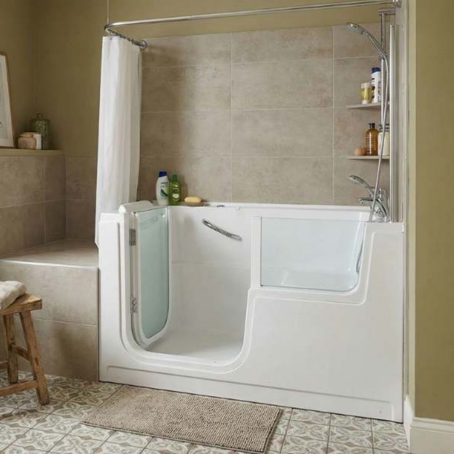 Port Royal SC walk-in tub shower combo with glass door, built-in seat, grab bar, handheld showerhead, beige tile walls and patterned floor for safe accessible senior bathing.