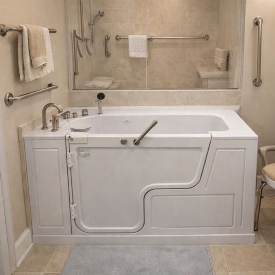 Sea Island GA walk-in tub in a fully accessible beige bathroom with outward-swinging door, grab bars, handheld shower, chrome fixtures and non-slip flooring designed for safe senior